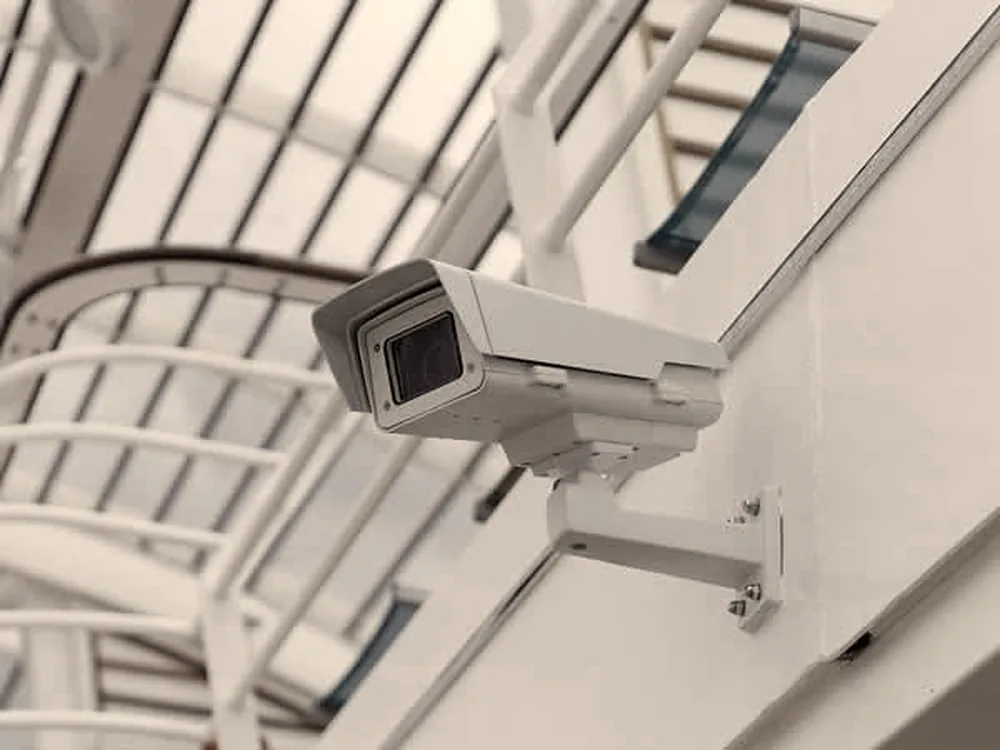 Camera on a wall bracket under a soffit